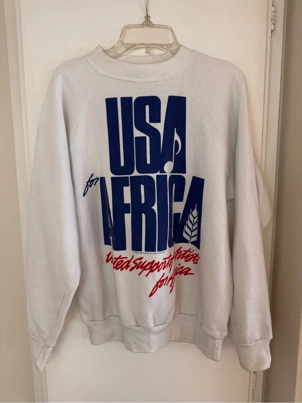 Vintage White Crewneck Sweatshirt with Bold Blue and Red USA for Africa Graphic